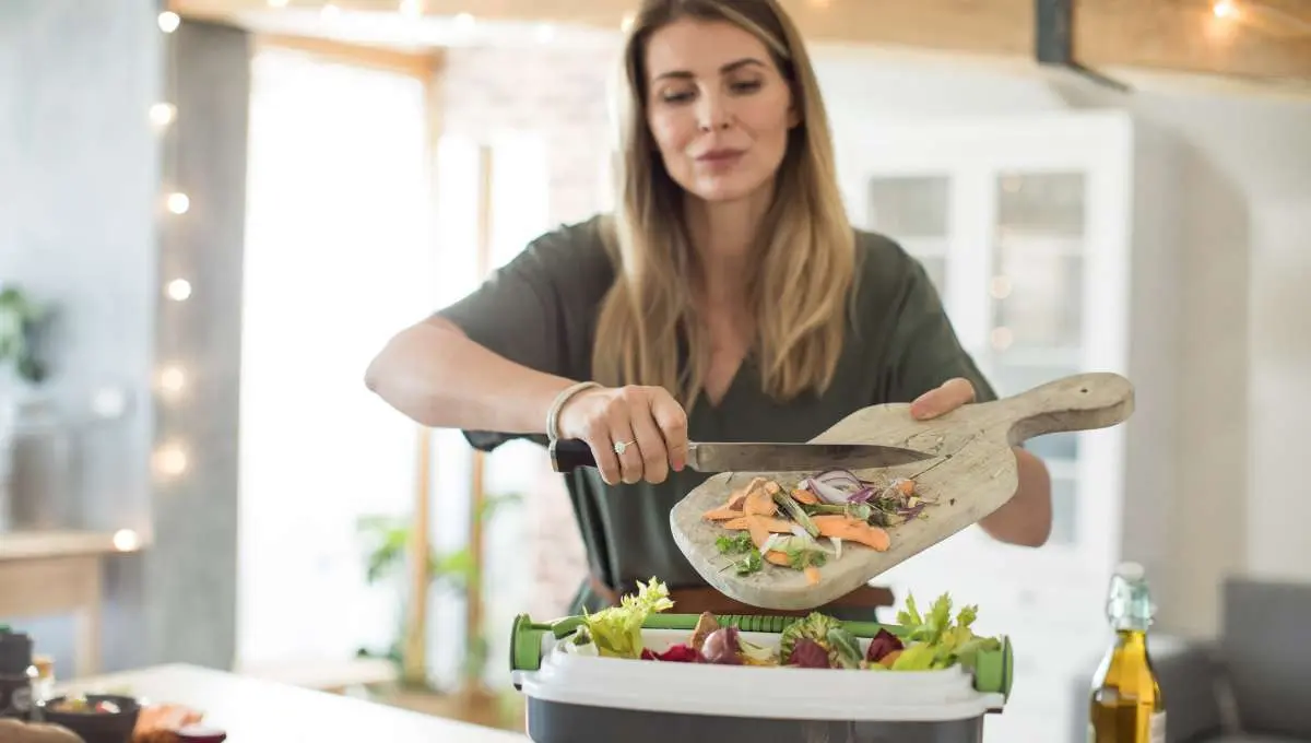 a lady putting leftover vegetables in container