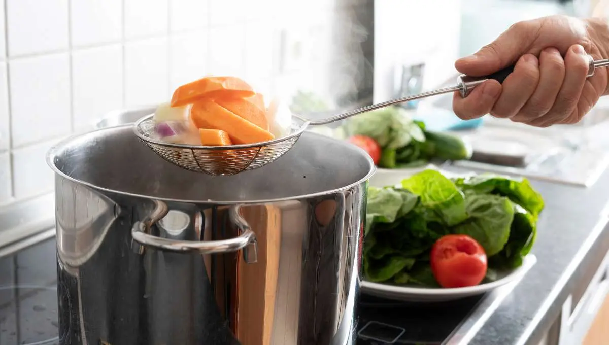 a chef boiling vegetables 